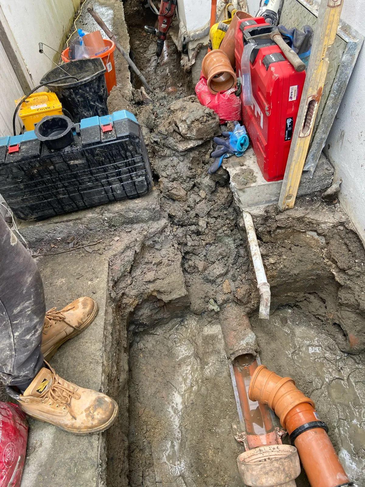 Working on pipes in the ground outdoors