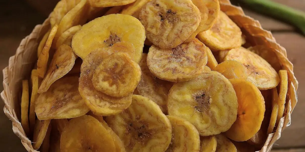 Golden banana chips in a basket — comparing the nutrition of Kerala banana chips versus potato chips