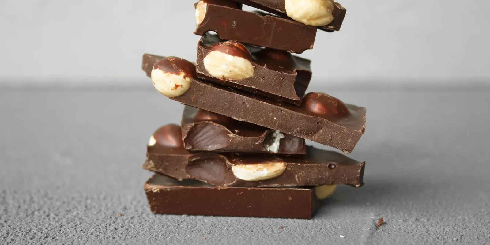 Broken bars of milk and dark chocolate stacked together, showing the colour difference between chocolate types