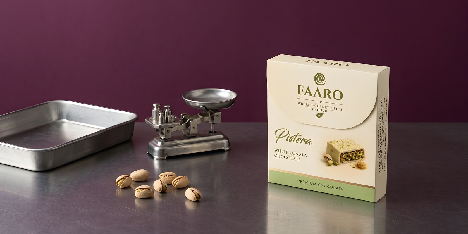 Faaro white kunafa chocolate cartons on a brushed steel surface with more packed in a steel tray, against a deep plum backdrop