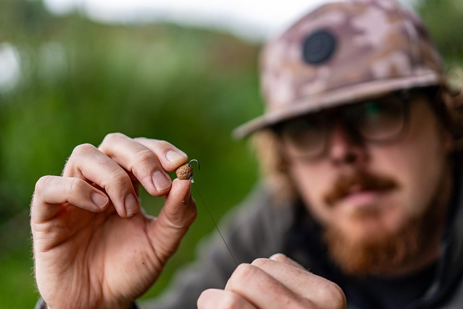Joe holding up a baited hook, a wafter on a hair rig