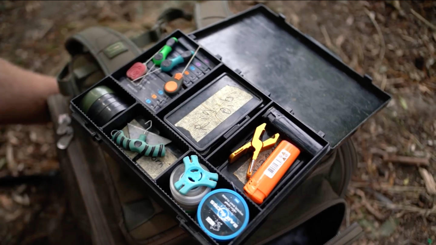 Organized Nash Box Logic carp tackle box with rig tools, hooks, swivels, and terminal tackle
