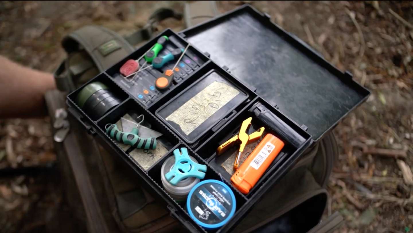 Organized Nash Box Logic carp tackle box with rig tools, hooks, swivels, and terminal tackle