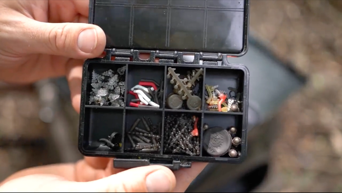 Labeled mini terminal tackle box with carp rig bits, line aligners, and bait stops