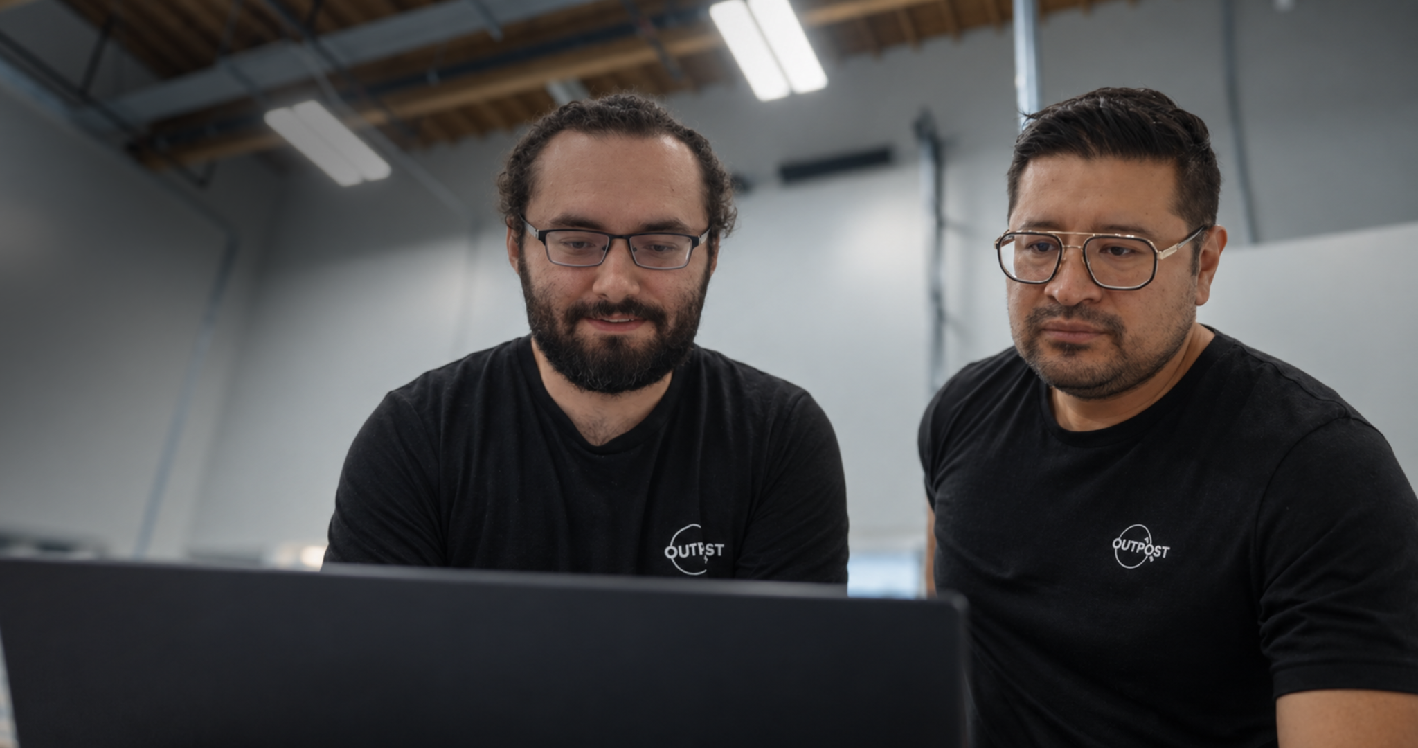Two outpost engineers reading test flight data