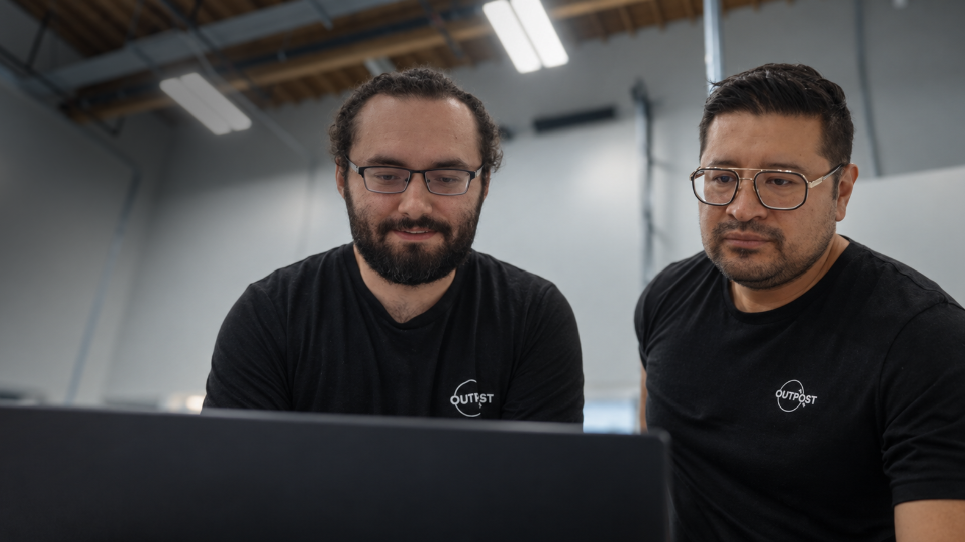 Two outpost engineers reading test flight data