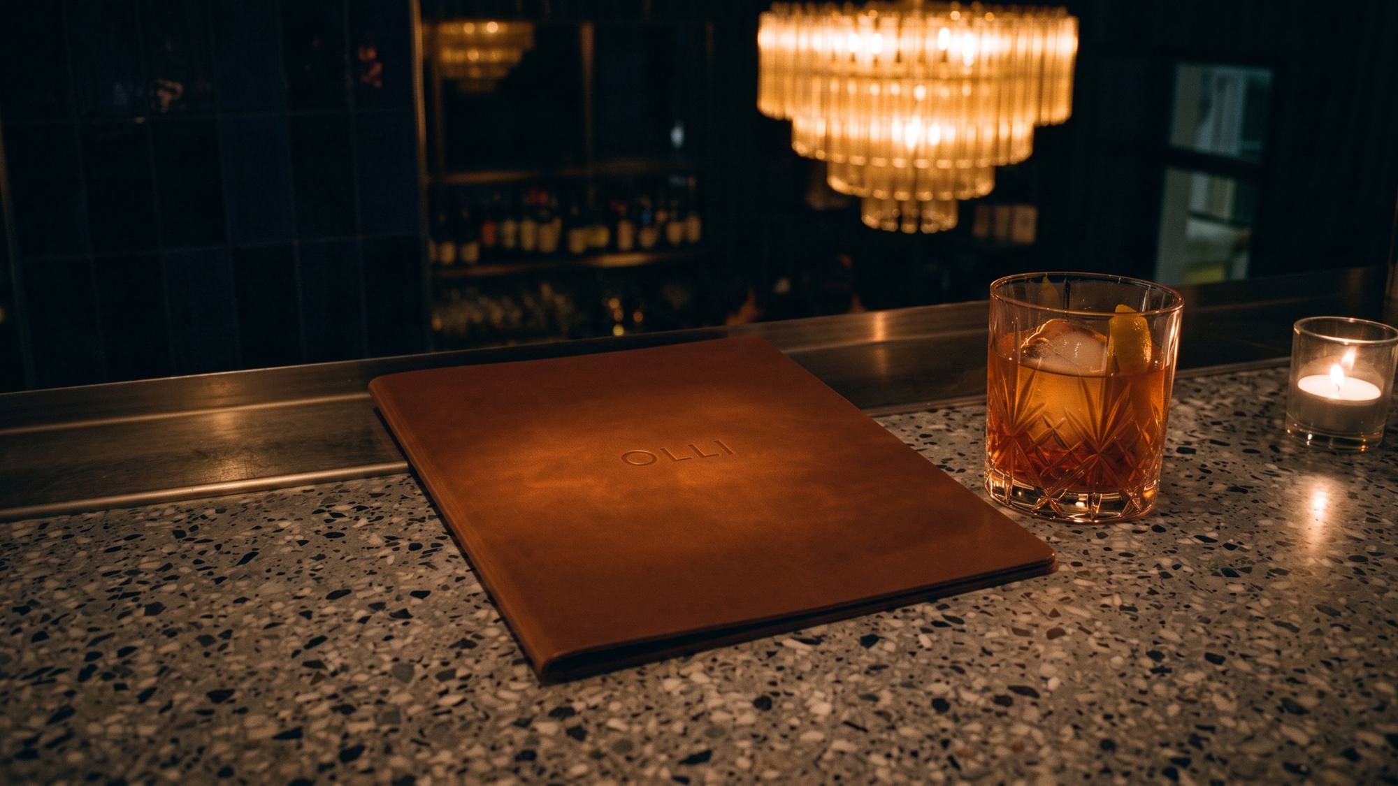 Ristorante Olli: 01.1 · ol05 hero · leather menu folder on the stone bar