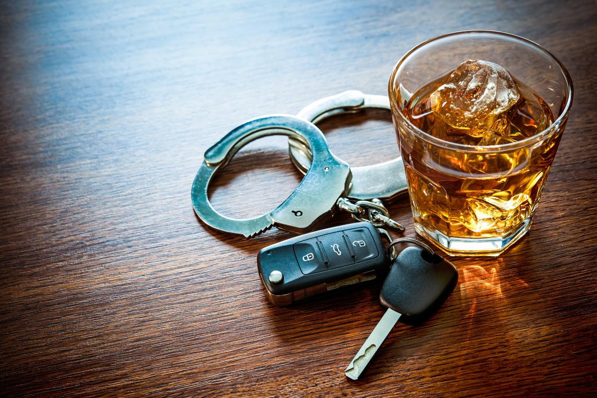 Alcohol and a car key on a wooden table