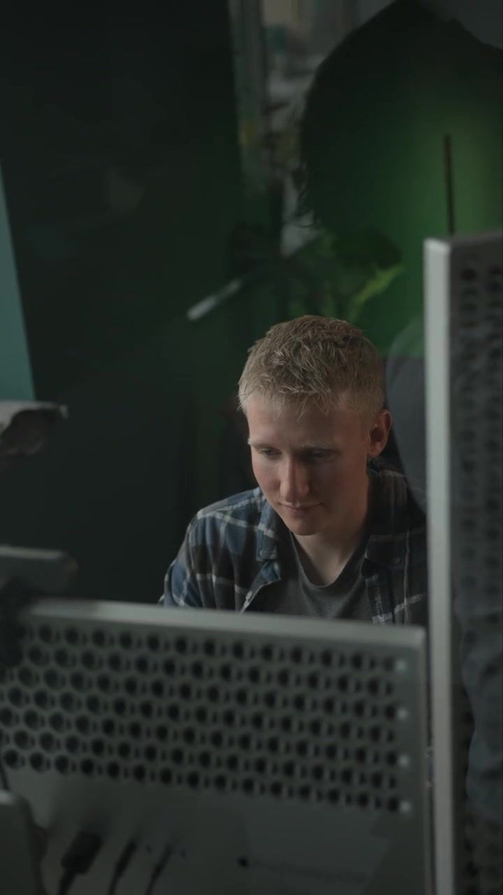 A Setsail team member working at his desk beneath the star mural in the Vancouver office
