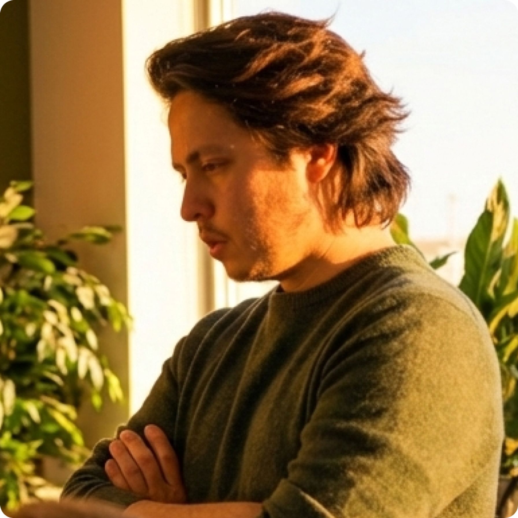 Jason Atakhanov, founder and CEO of Setsail Marketing, arms crossed by a sunlit window