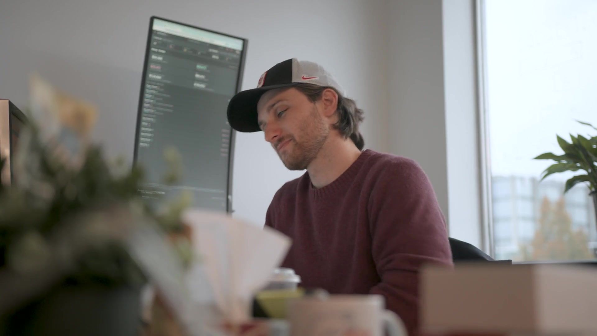 A Setsail team member smiling as he works at his laptop in the Vancouver office