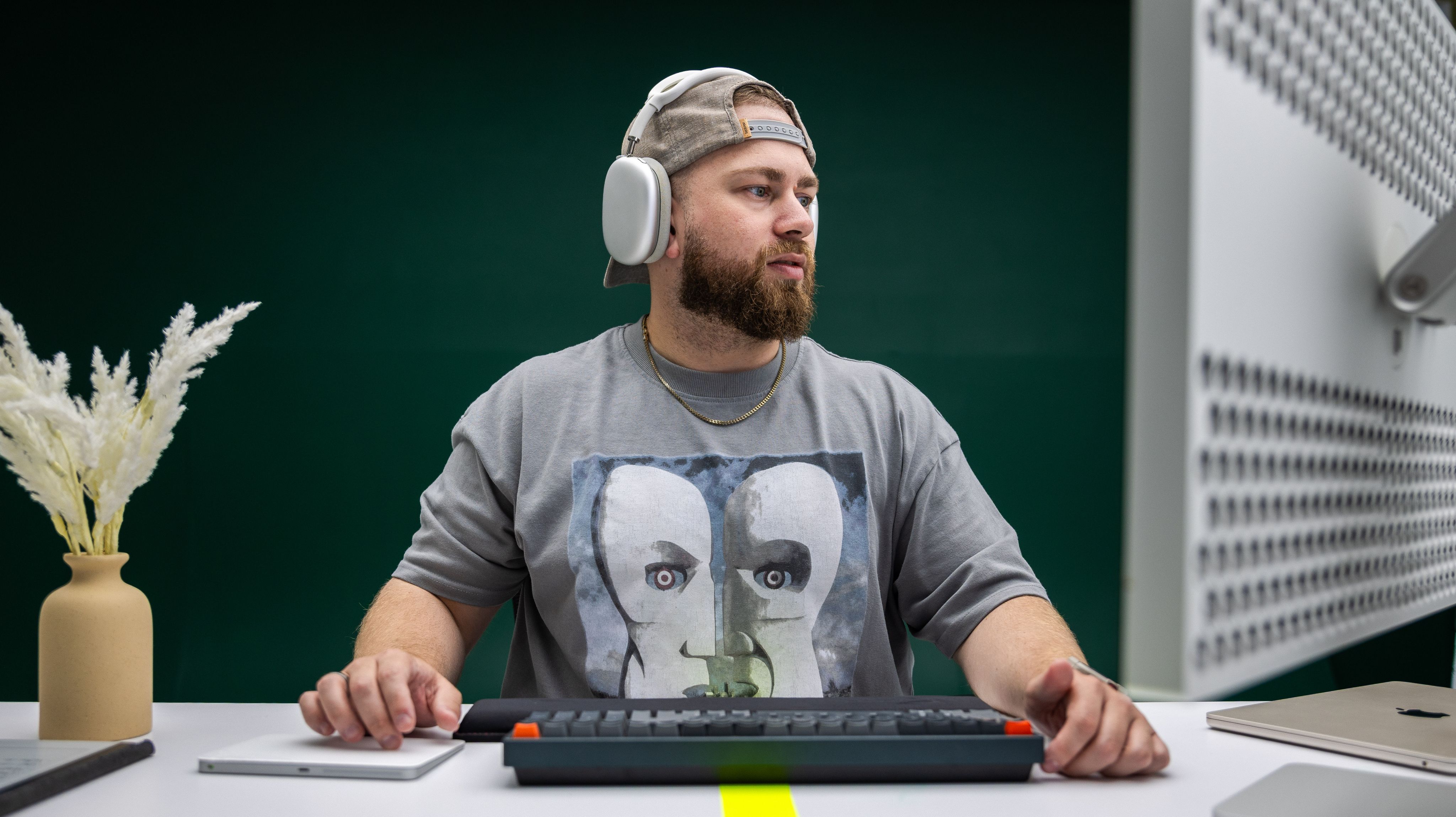 A specialist in headphones working at a desk in the studio