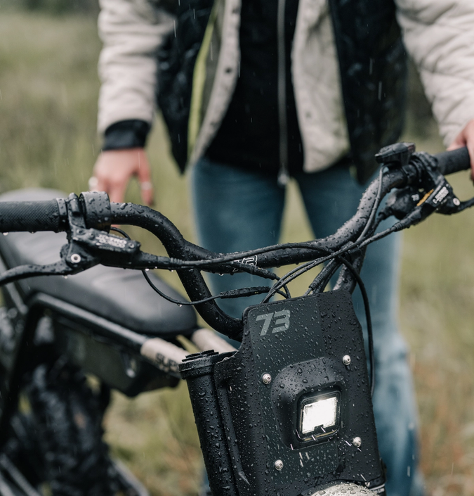 someone using water to clean their e-bike
