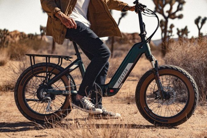 Lower portion of a man riding an Aventon Folding Electric Bike