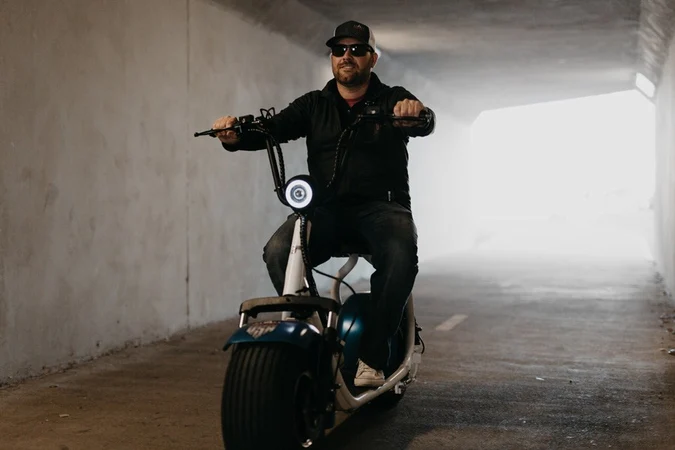 Bobby Corrales riding phat tire scooter in a tunnel