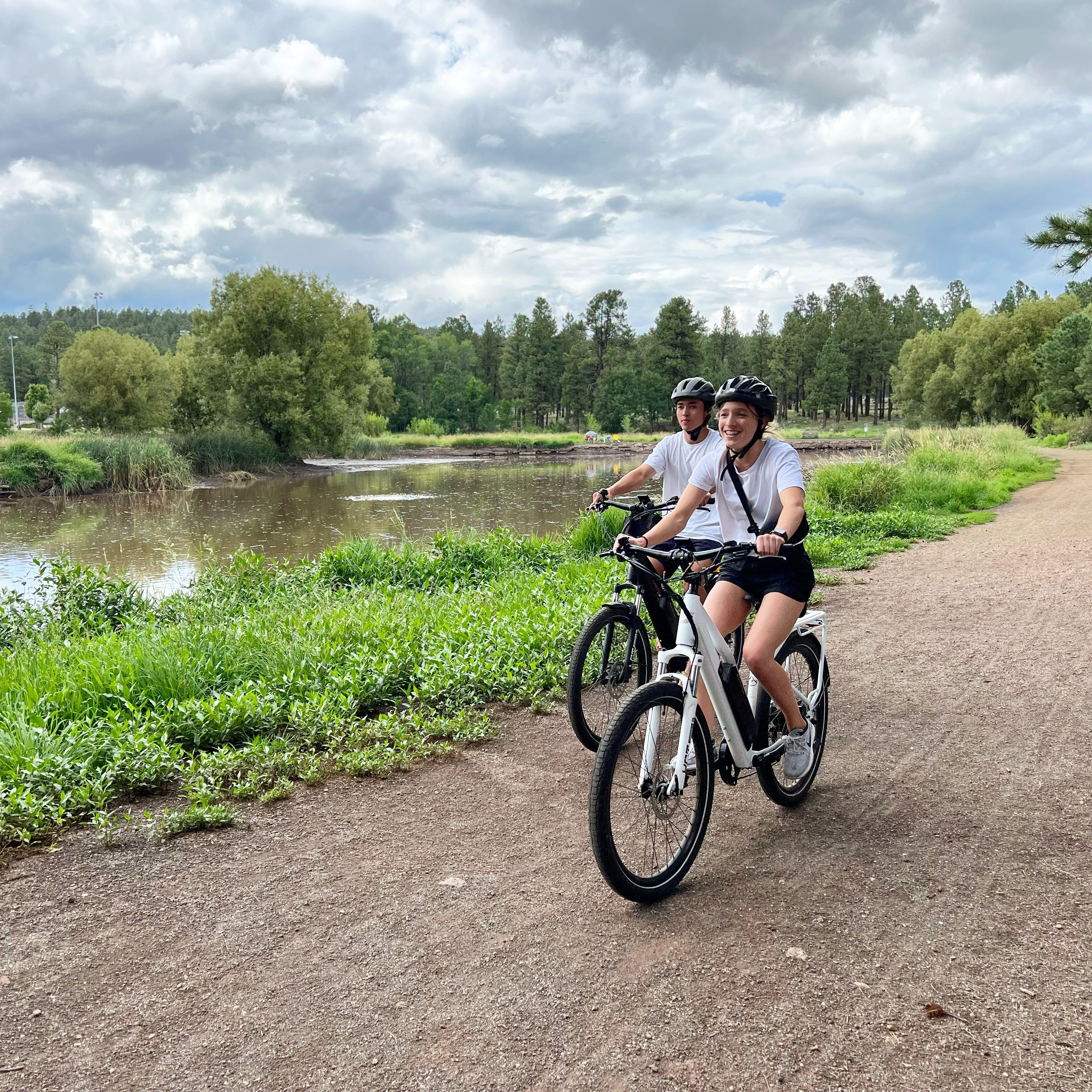 two people riding electric trail bikes