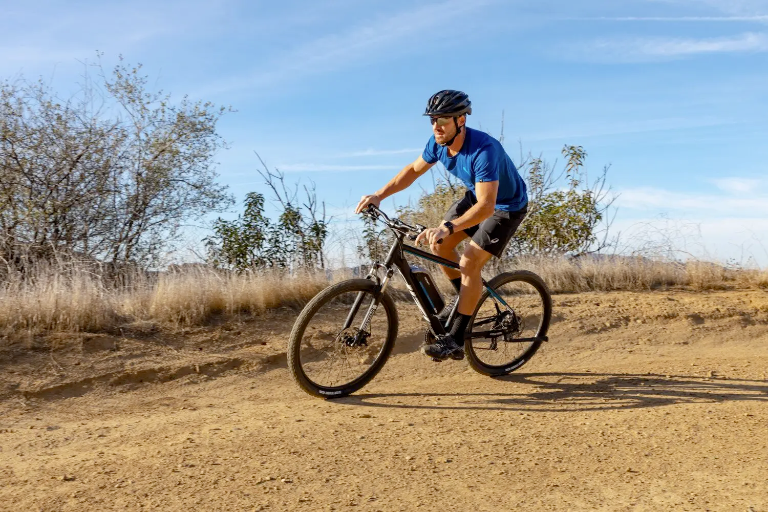 Man riding electric bike on desert trail