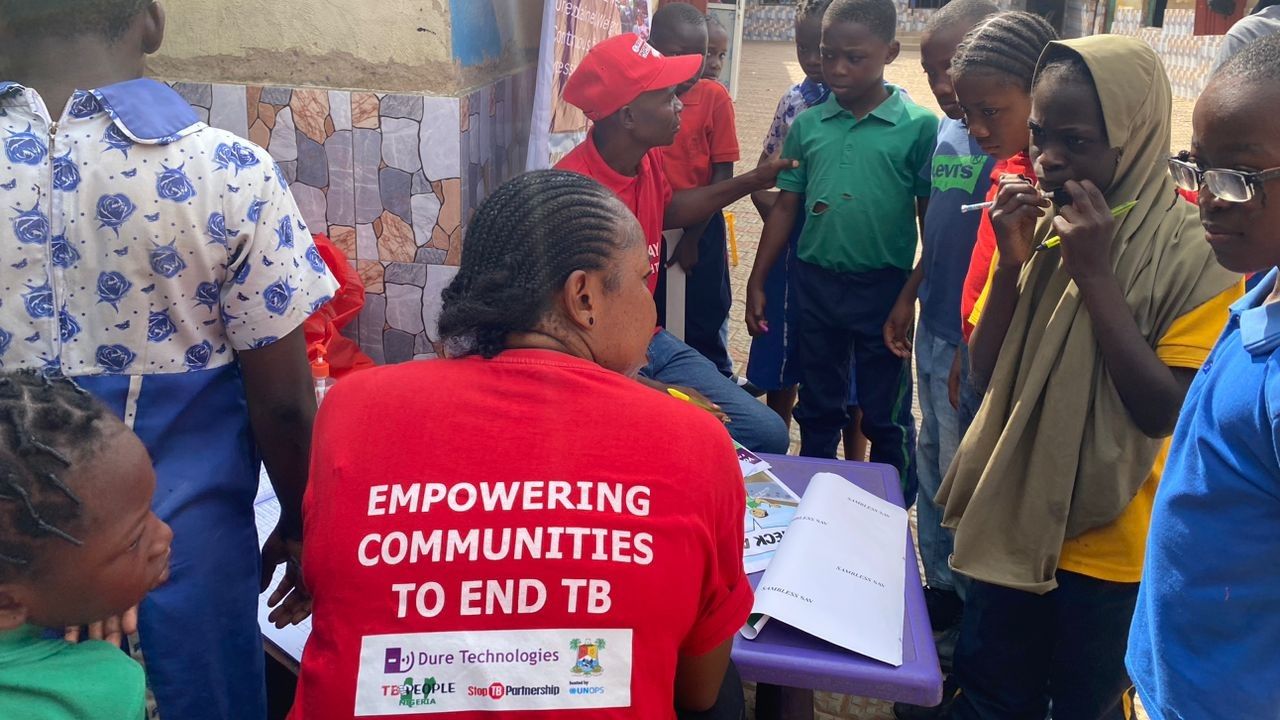 Children and adults being screened for TB symptoms during outreach.