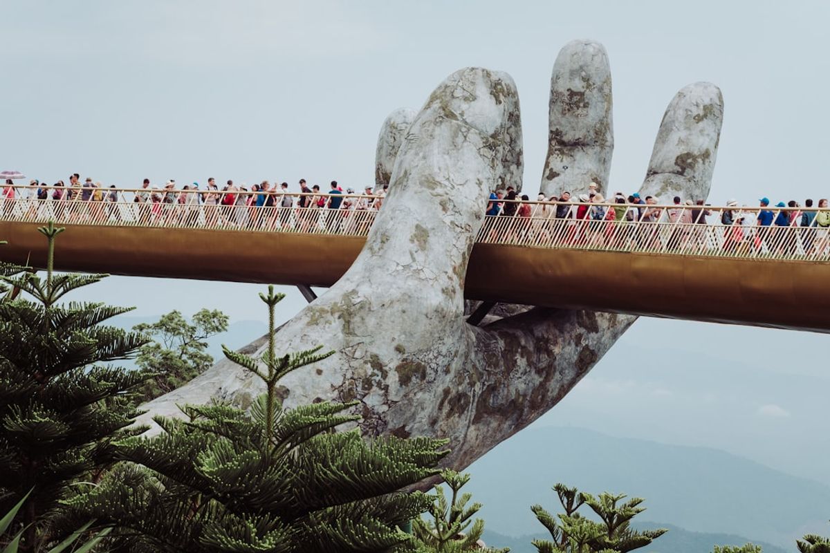 The Golden Bridge held by giant stone hands at Ba Na Hills, Da Nang