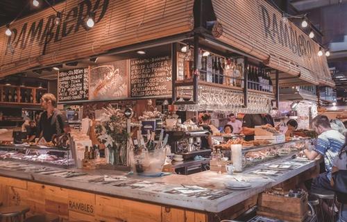 Colorful fruit stalls inside La Boqueria Market