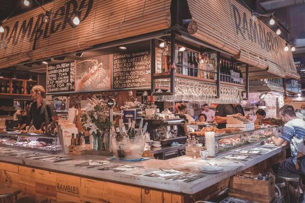Colorful fruit stalls inside La Boqueria Market