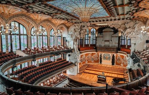 The spectacular stained glass skylight of the Palau de la Música Catalana concert hall, exploding with colour and light above the central performance space