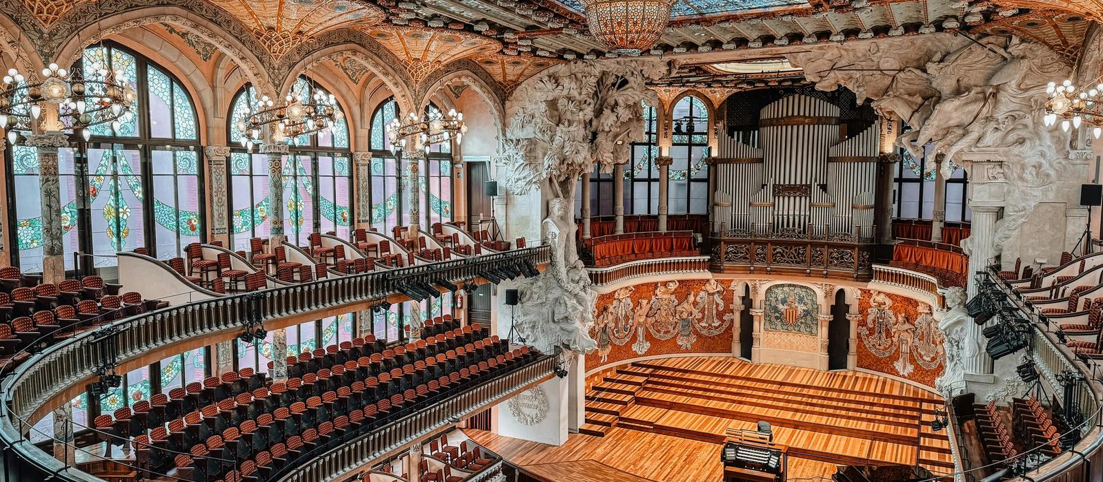 The spectacular stained glass skylight of the Palau de la Música Catalana concert hall, exploding with colour and light above the central performance space