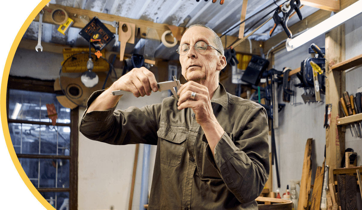 A photo of a man with a tool in his workshop