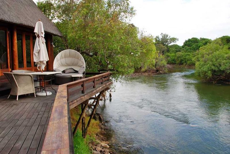 "Katombora Island is one of many that clutter the upper Zambezi in the broad floodplain above Victoria Falls. The water was at its lowest, but there was still a swift current swirling around the island, drawn by the 300-foot drop off at Victoria Falls downstream. Our room overlooked the channel between Katombora and another small island."