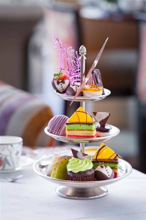 Three-tiered tray with colourful cakes at Table Bay Hotel