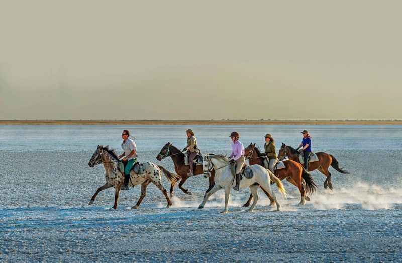 Horse riding across the dry pans