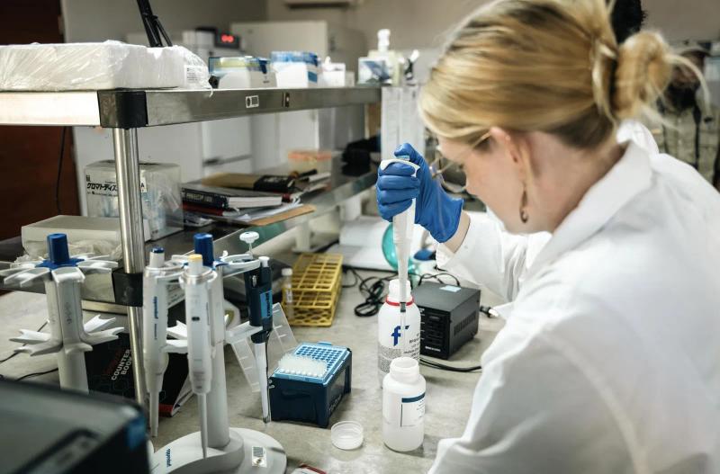 Researcher in a laboratory at Gorongosa’s scientific research centre examining a sample.