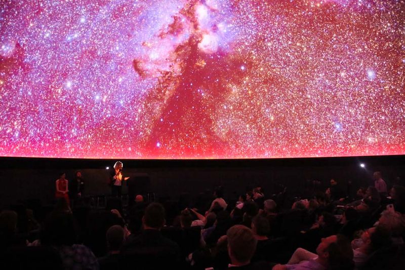 Visitors enjoying a presentation about the solar system at the Iziko Planetarium