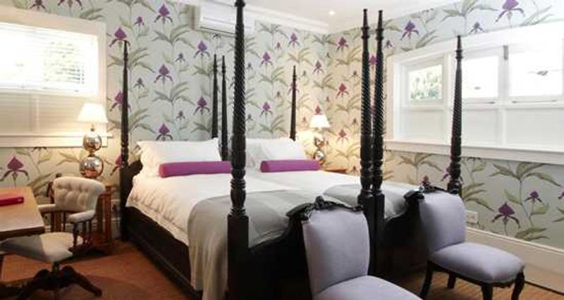 Deep purple varietals of the unique and fragile orchid plant adorn the walls of the Orchid Room