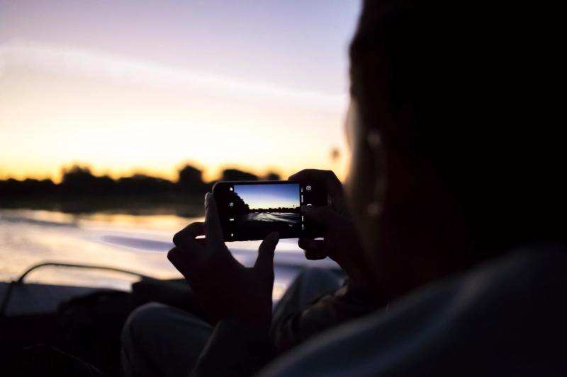 Rhino Africa travel expert on a sunset river cruise on the Okavango Delta