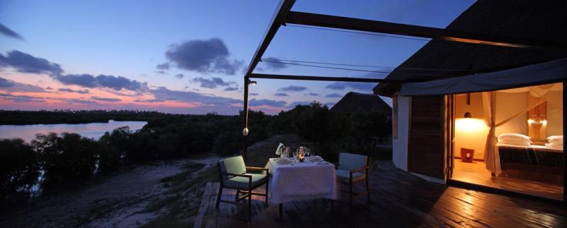 A dinner set up on the deck of a luxury villa at coral lodge 1541