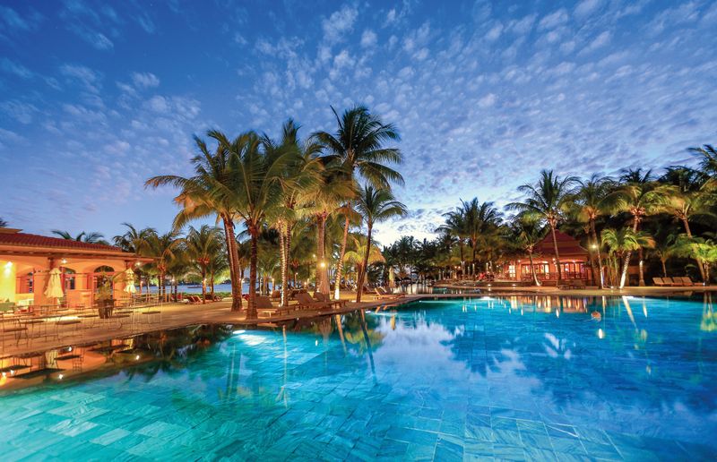 Pool at night at Mauricia Beachcomber Resort & Spa