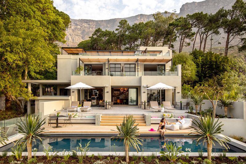 A couple lounging by the pool at Camissa House