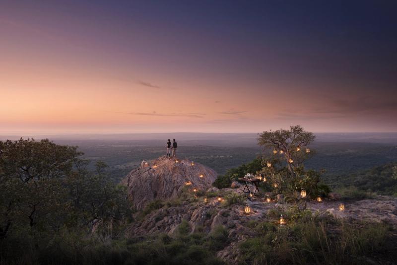 Lantern-lit sundowner setting overlooking the wilderness at Phinda Private Game Reserve in South Africa.