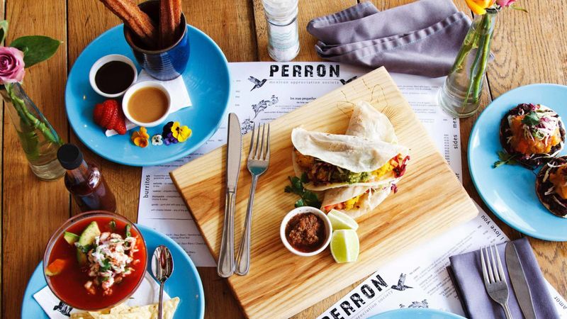 Platters and plates of colourful Mexican food 