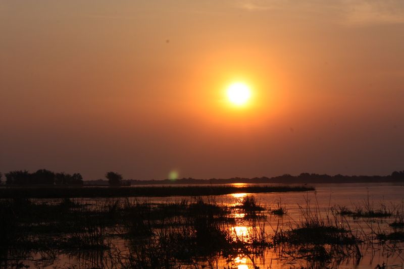 A vivid sunset over the Lower Zambezi on a Zambia safari