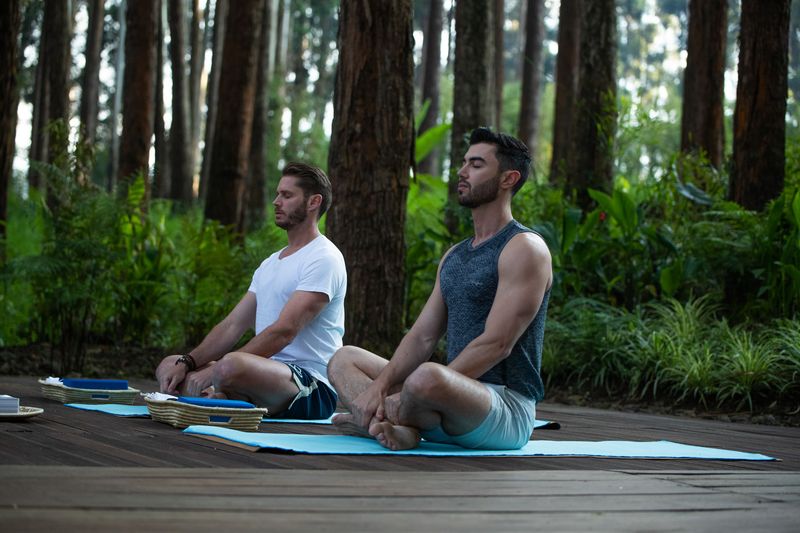 two men meditating in the forest at One&Only Gorilla's Nest
