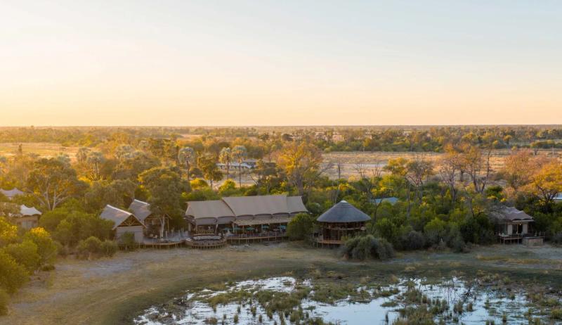 Aerial view of Atzaró Okavango Camp surrounded by trees in Botswana's Okavango Delta.