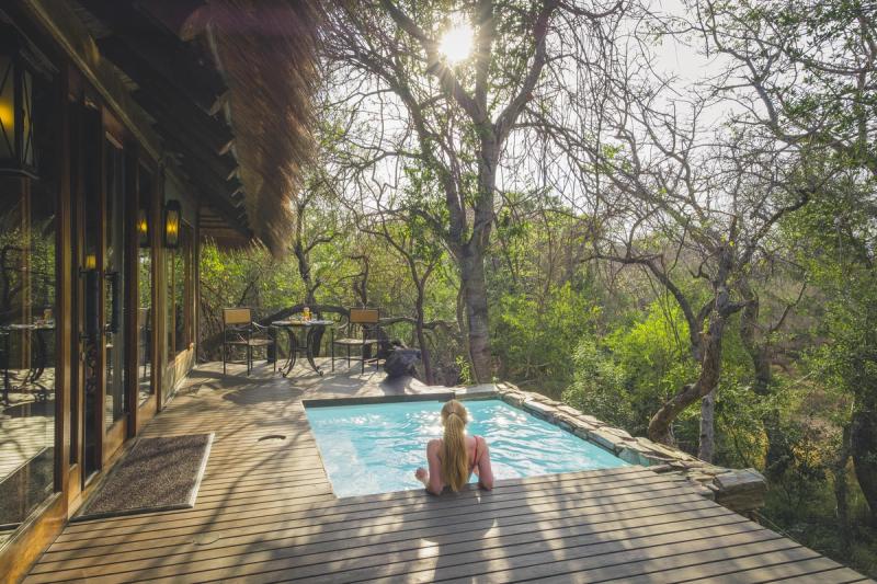 Girl sitting in her private swimming pool at Jabulani Safari