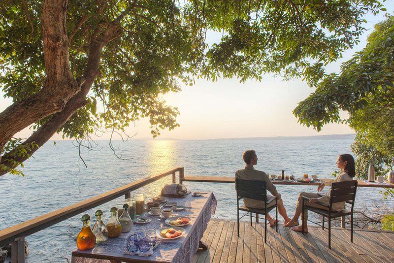 Couple having breakfast overlooking Lake Victoria, one of Tanzania's most beautiful lakes