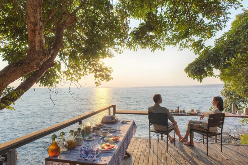 Couple having breakfast overlooking Lake Victoria, one of Tanzania's most beautiful lakes