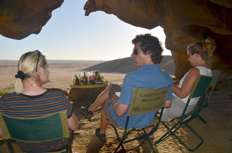 Patti and her friends sitting amongst boulders enjoying the view and drinks