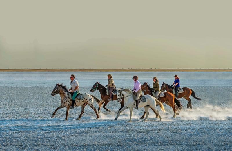 Horse riding across the dry pans