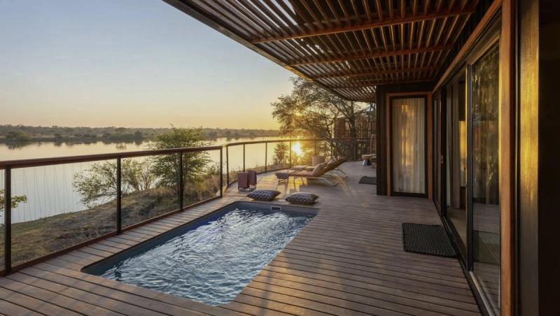 A private deck with a plunge pool overlooks the river at sunset, offering a calm retreat within the new luxury safari lodges 2026.