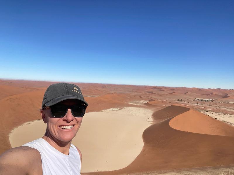 Peggy standing on the summit of Big Daddy overlooking Deadvlei and the dunes of Sossusvlei, Namibia.